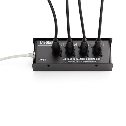 Front view—SNK4BM with four labeled XLR-M channels (1–4) plugged in